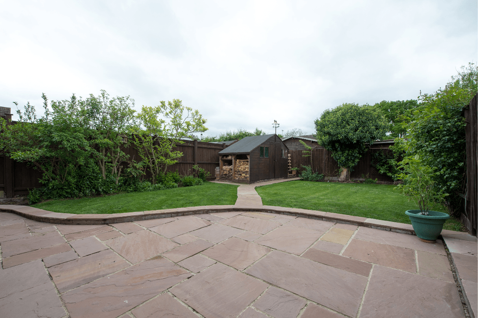 A garden patio with a lawn