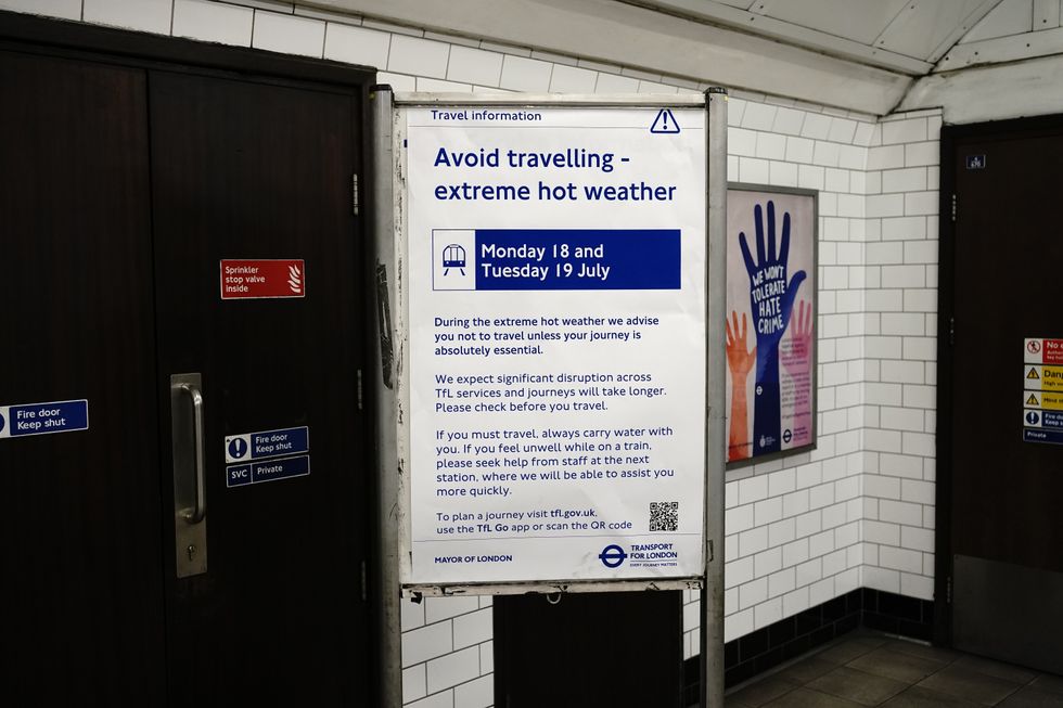 A sign warning passengers of traveling in the heat on the Bakerloo line of the London underground