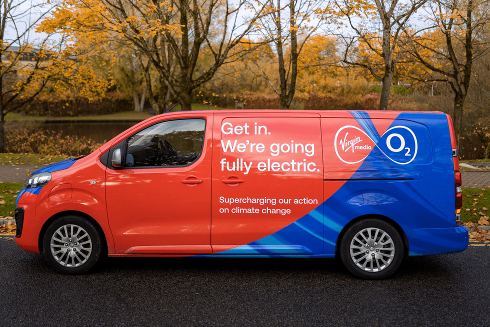 a virgin media o2 van is pictured parked on the side of the street in autumn