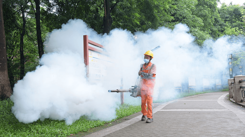 A worker spraying insecticide