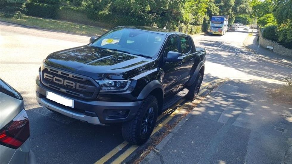 Car parked on yellow lines