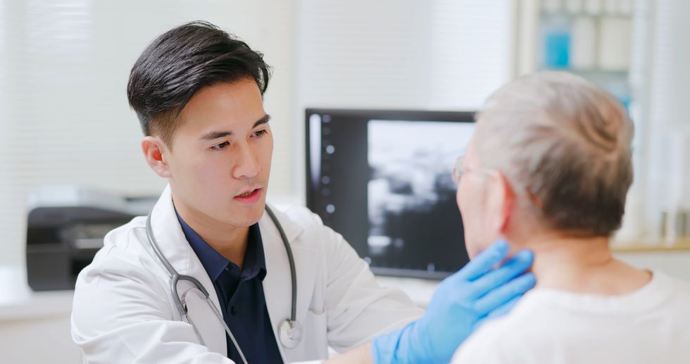 Doctor assessing patient's neck