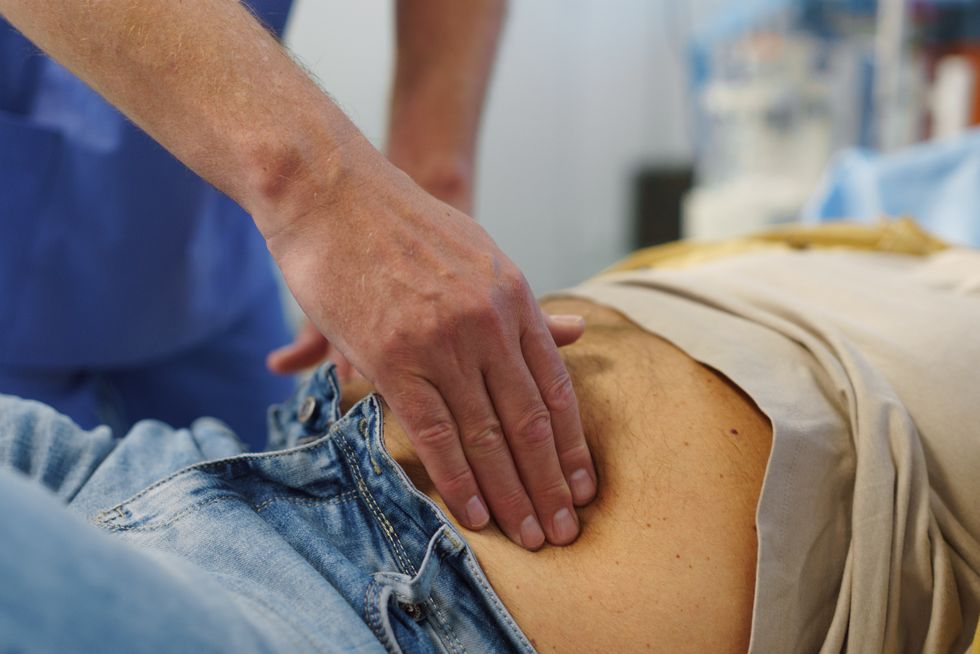 Doctor examining abdominal area