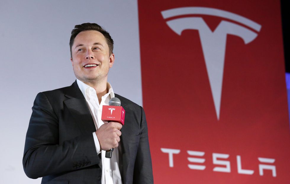 Elon Musk and a Tesla logo