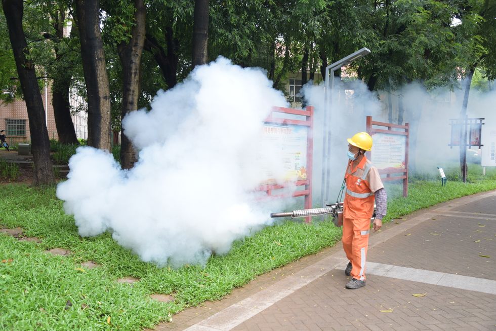 Health workers fumigating public spaces