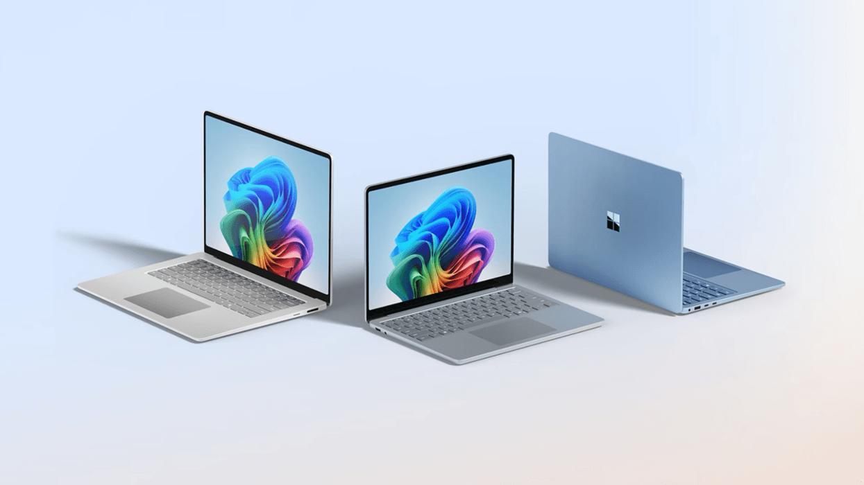 laptops running windows 11 pictured side by side on a plain background