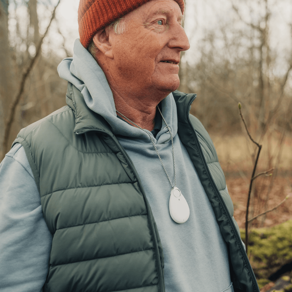 Man wearing personal alarm device