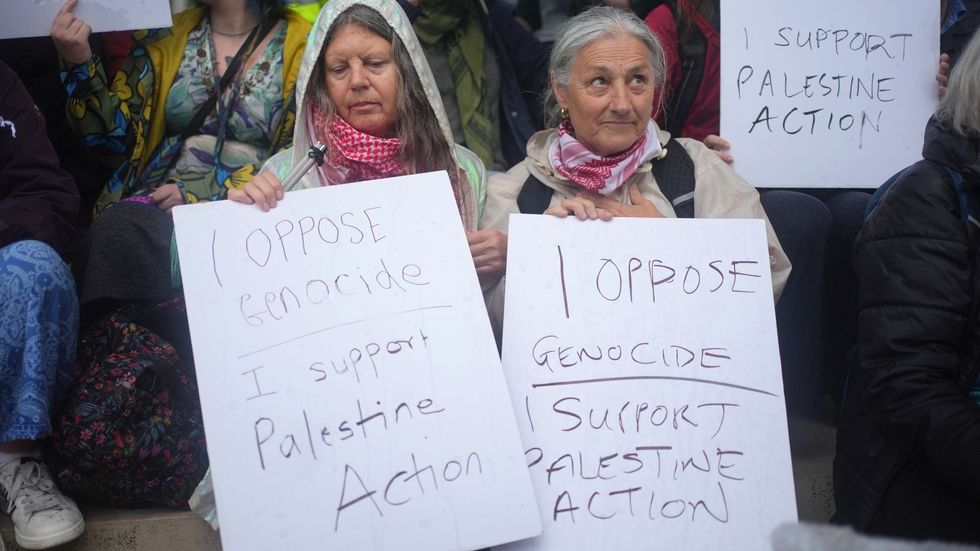Protesters have been holidng placards reading: 'I oppose genocide, I support Palestine Action'