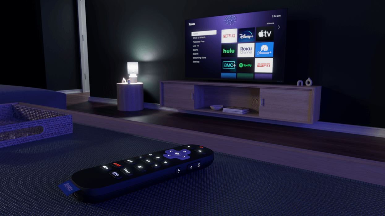 Roku Streaming Stick on table in front of a television