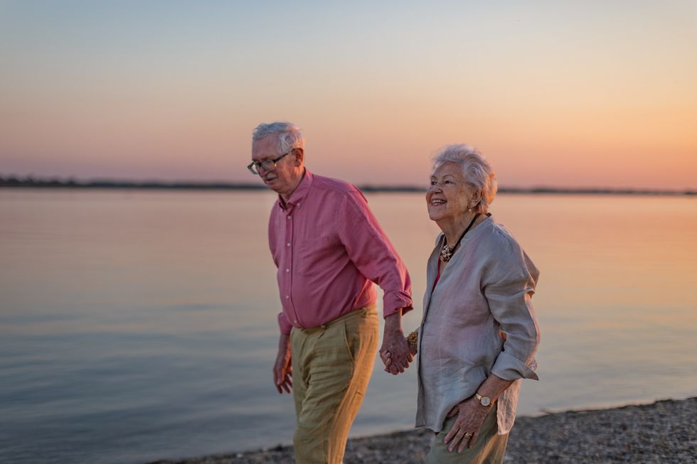 SENIOR COUPLE WALKING ON BEACH