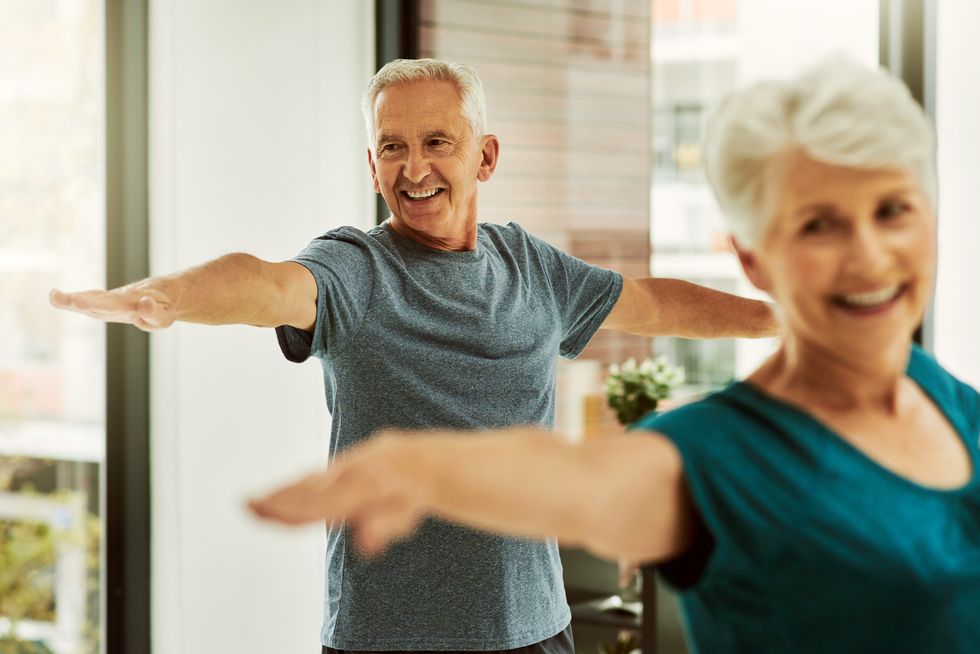 Senior man and woman exercising