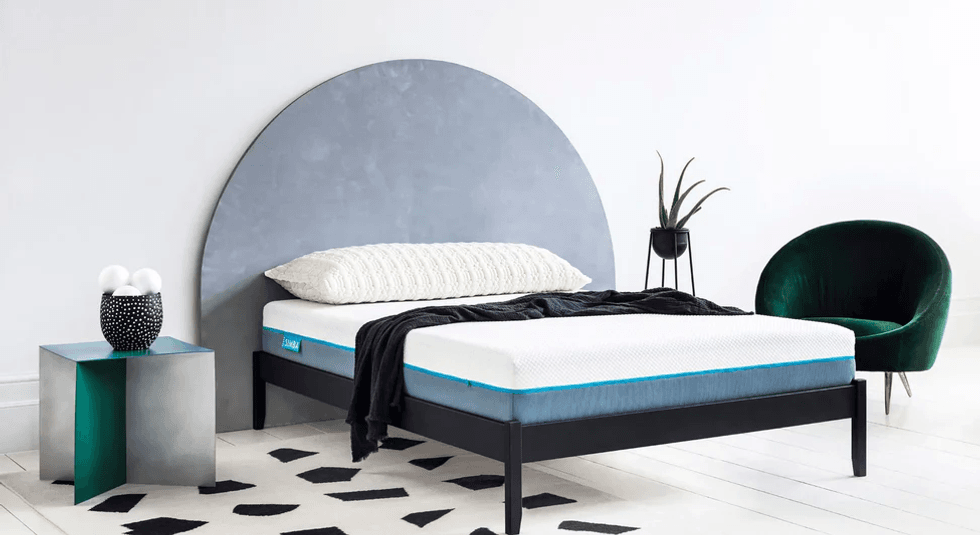 Simba mattress atop a bed, styled with a pillow and blanket