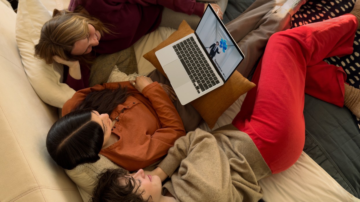 three girls on the sofa watching a show on the new macbook air