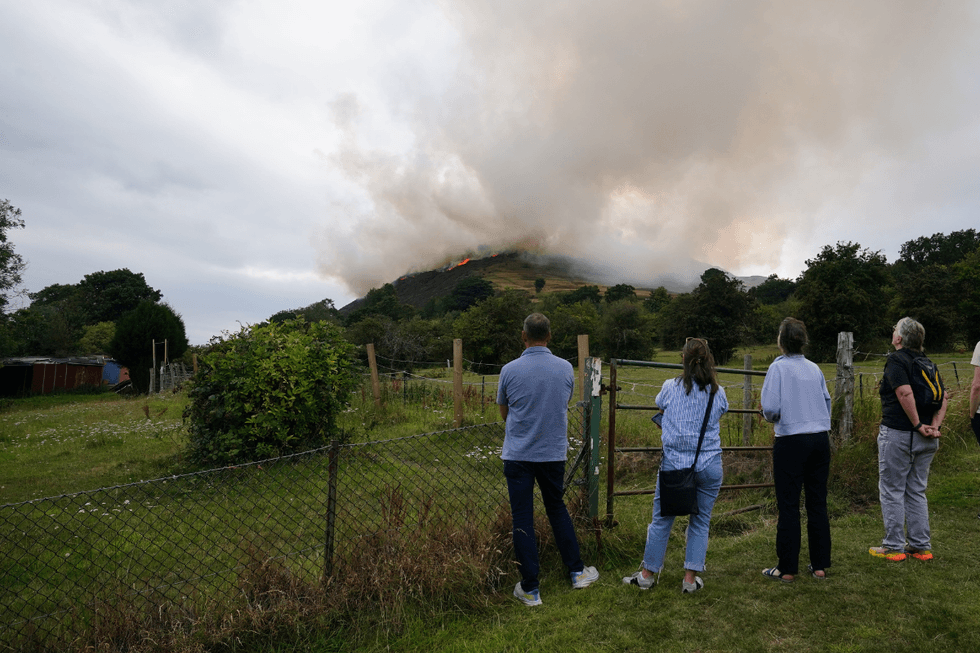 \u200bMembers of the public watch the large clouds of smoke from the fire on Arthur's Seat in Holyrood Park