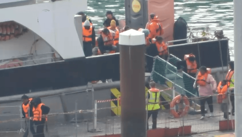 \u200bMigrants disembark from Border Force vessel this morning (August 8, 2025)