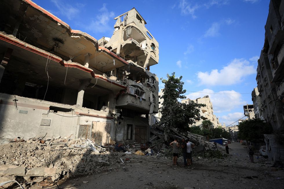 \u200bPalestinians inspect the site of an overnight Israeli strike on a house, in Gaza City