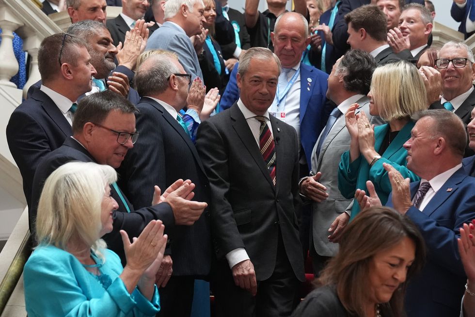 \u200bReform UK leader Nigel Farage is applauded by members of Kent County Council