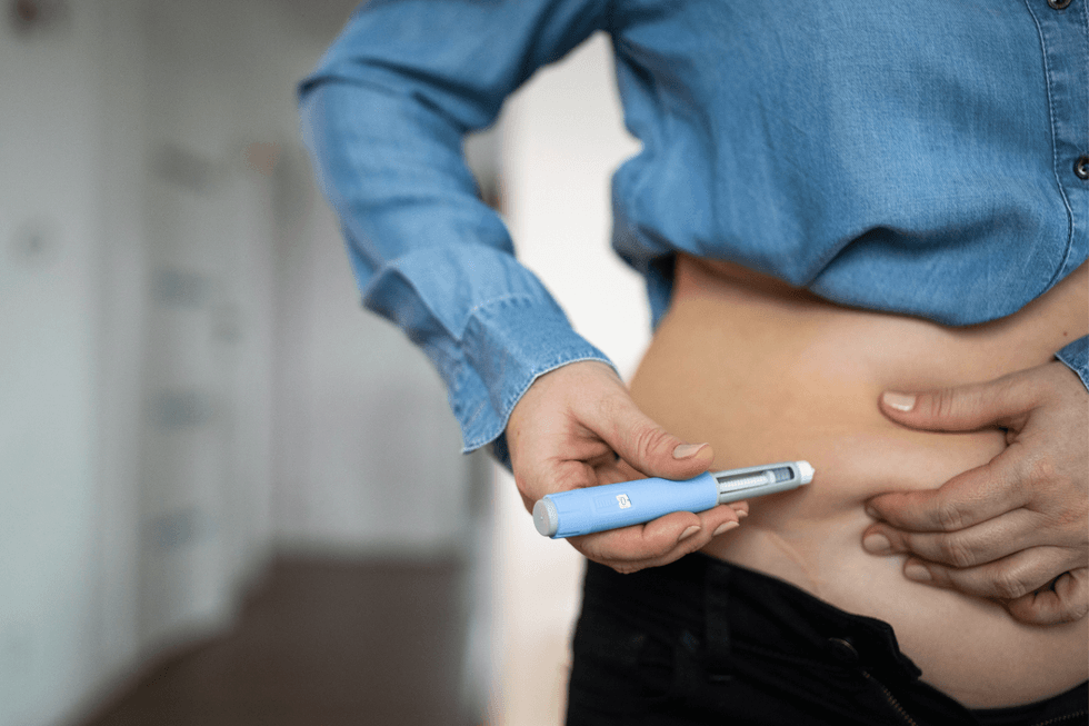 User injecting weight loss jab