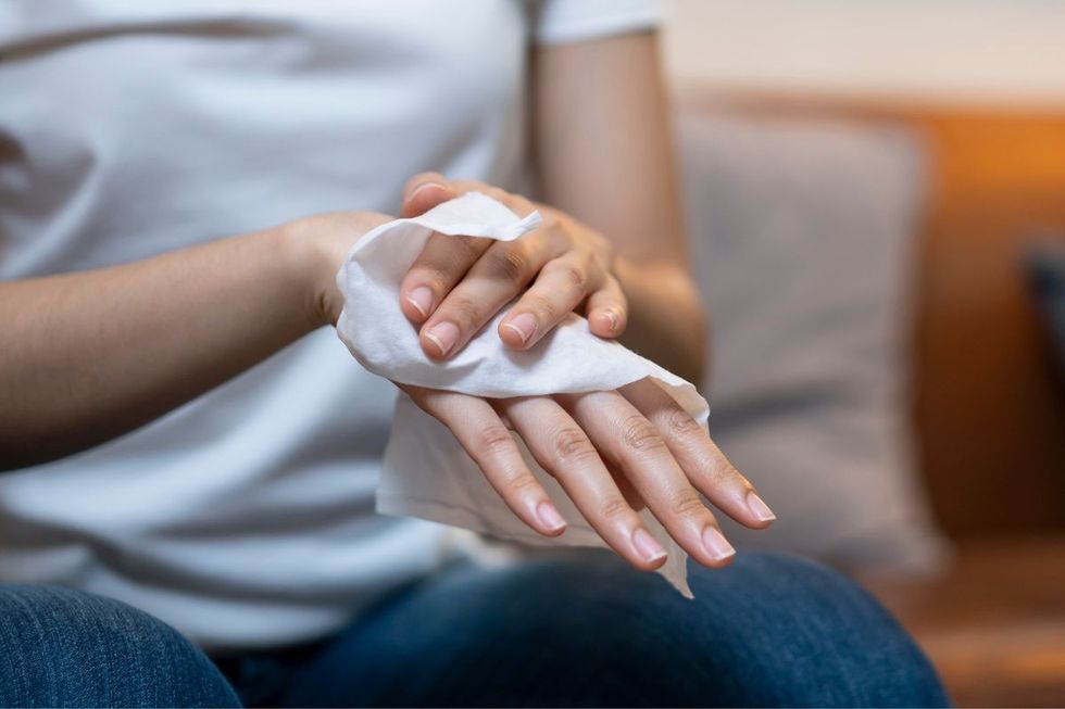 woman wiping hand