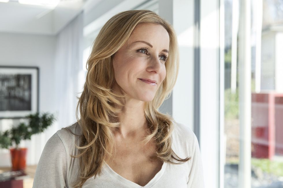 Woman with blonde hair and face-framing layers