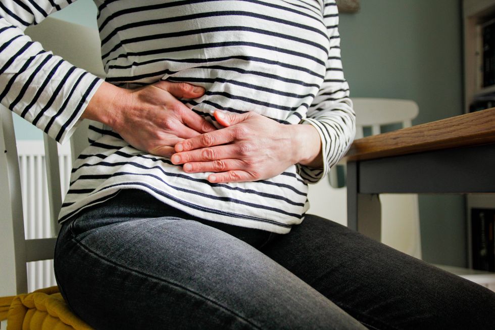 WOMAN WITH STOMACH PAIN